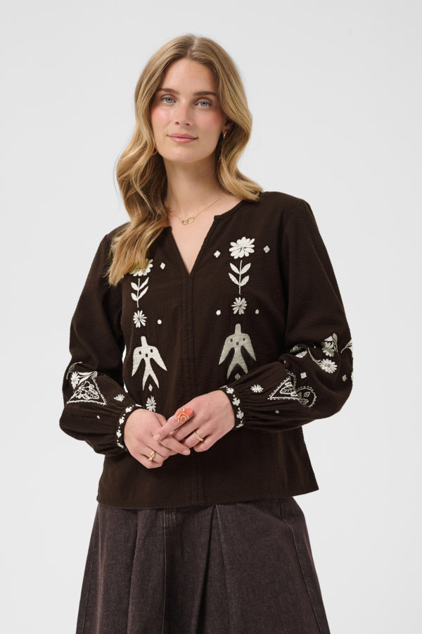 Cream Patulie Folk Embroidered Blouse with intricate embroidery and traditional design, displayed on a hanger.