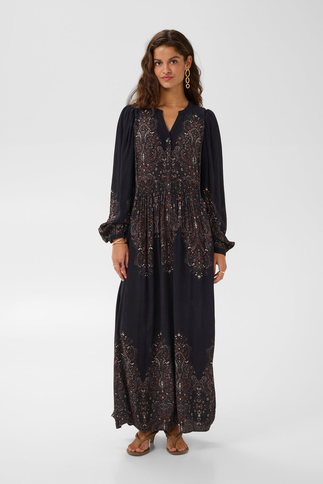 Cream Josia maxi dress displayed on a hanger, showcasing a flowing, elegant design with a fitted bodice and full-length skirt.