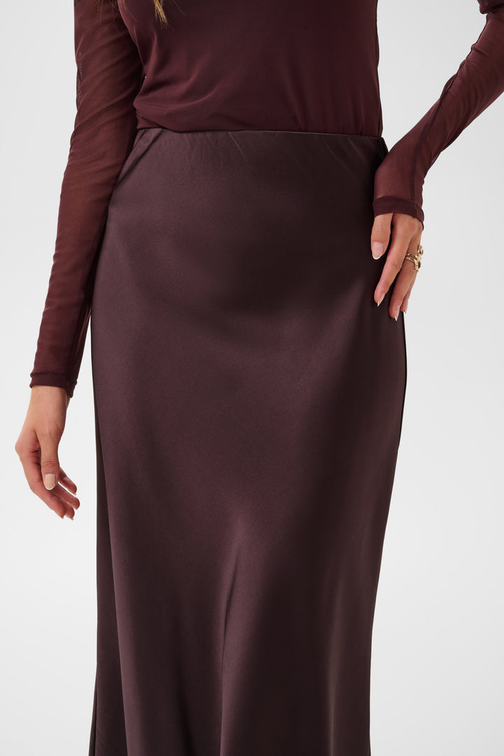 Cream Cocamia midi slip skirt in soft fabric, featuring a sleek silhouette and subtle slit detail, perfect for elegant everyday wear.
