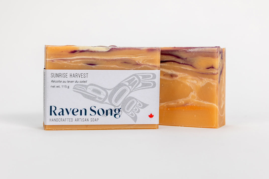 Hand soap by RavenSong Soap & Candle featuring Sunrise Harvest Citrus and Patchouli scent, with a natural soap bar and botanical accents.