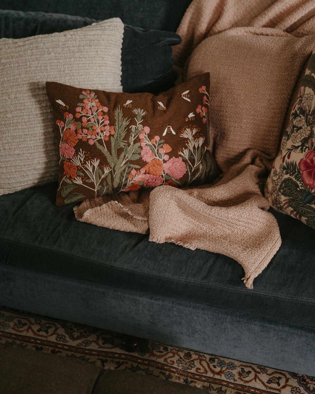 Cream-colored embroidered lumbar throw pillow by Creative Co-op with intricate floral design for decorative comfort.