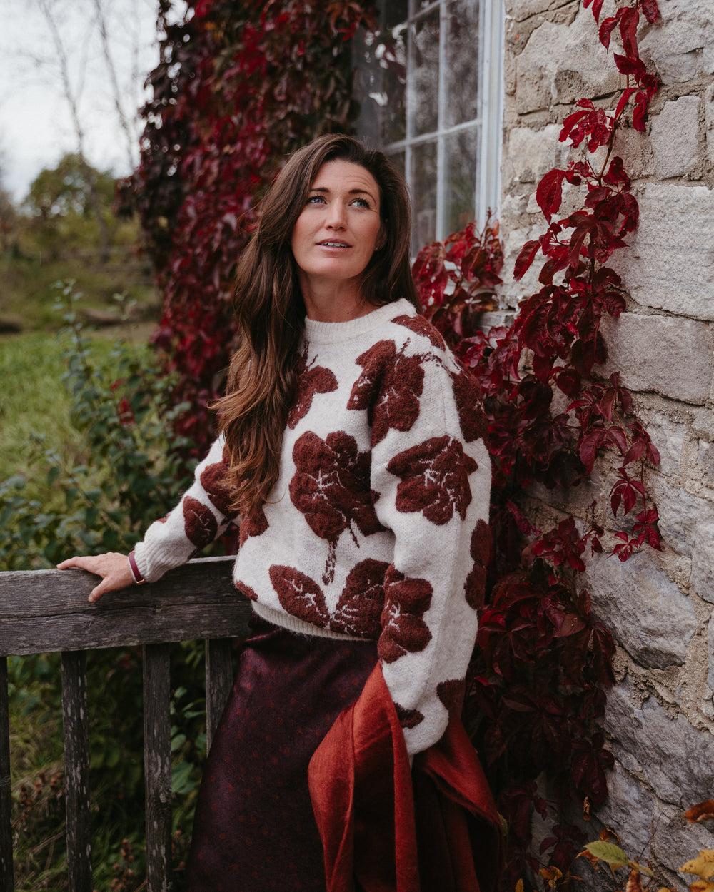B.Young Manda Floral Knit Sweater with colorful floral pattern, long sleeves, and cozy knit fabric on a neutral background.