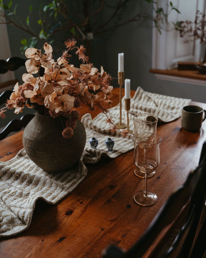 Indaba Serres earthy textured terracotta vase with a rustic finish, showcasing its warm, natural clay surface and handcrafted design.