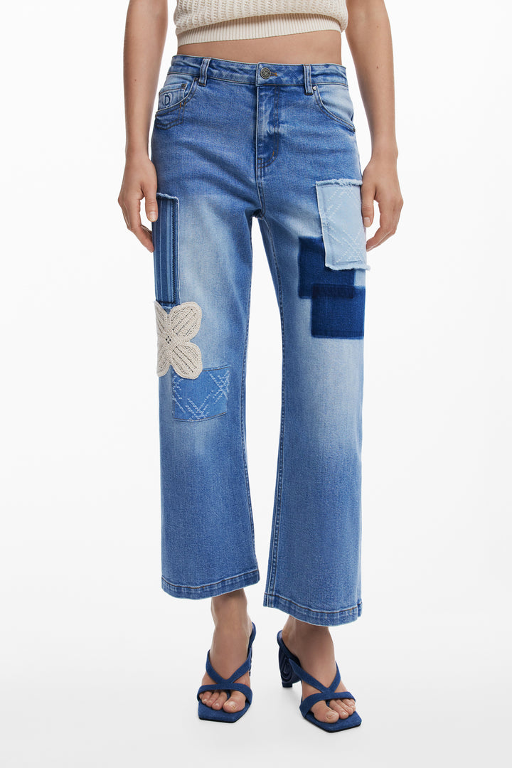 Daisy Mae Crop Jean by Desigual featuring distressed denim, high waist, retro inspired patchwork detail, and cropped length with a casual, stylish fit.