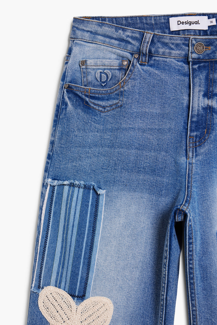 Desigual Daisy Mae Crop Jean showcasing high-waisted denim jeans with a relaxed fit and stylish distressed wash and  retro inspired patchwork details..