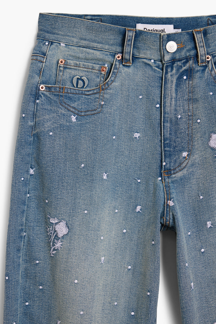 Desigual Cecilia Barrel Jeans featuring a relaxed fit and stylish design, displayed on a hanger with detailed floral stitching.
