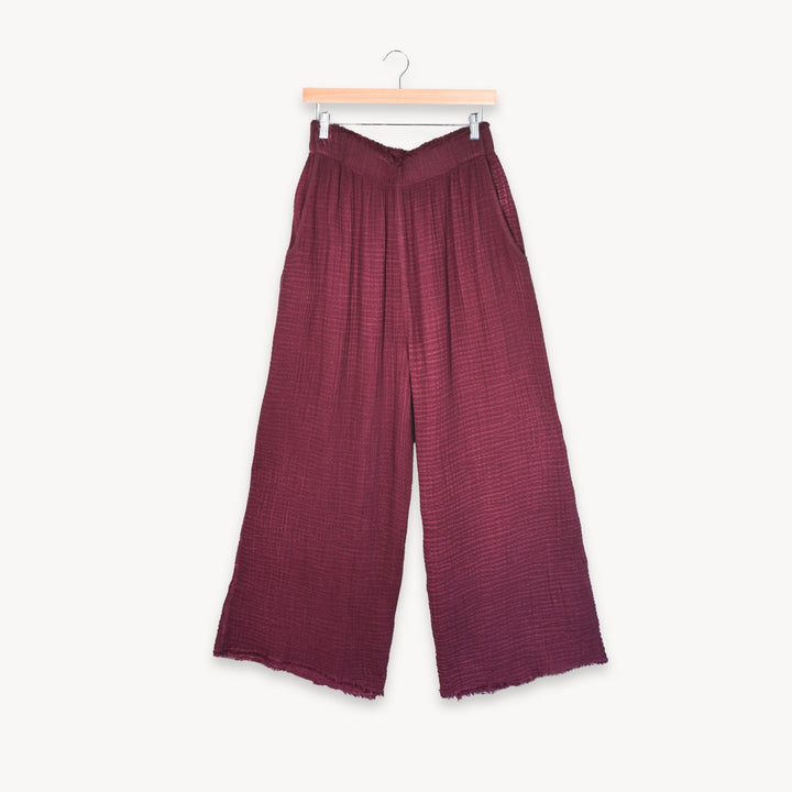 Cranberry crinkle cotton palazzo pants by Pokoloko with a relaxed fit and wide-leg style, displayed flat in the image.