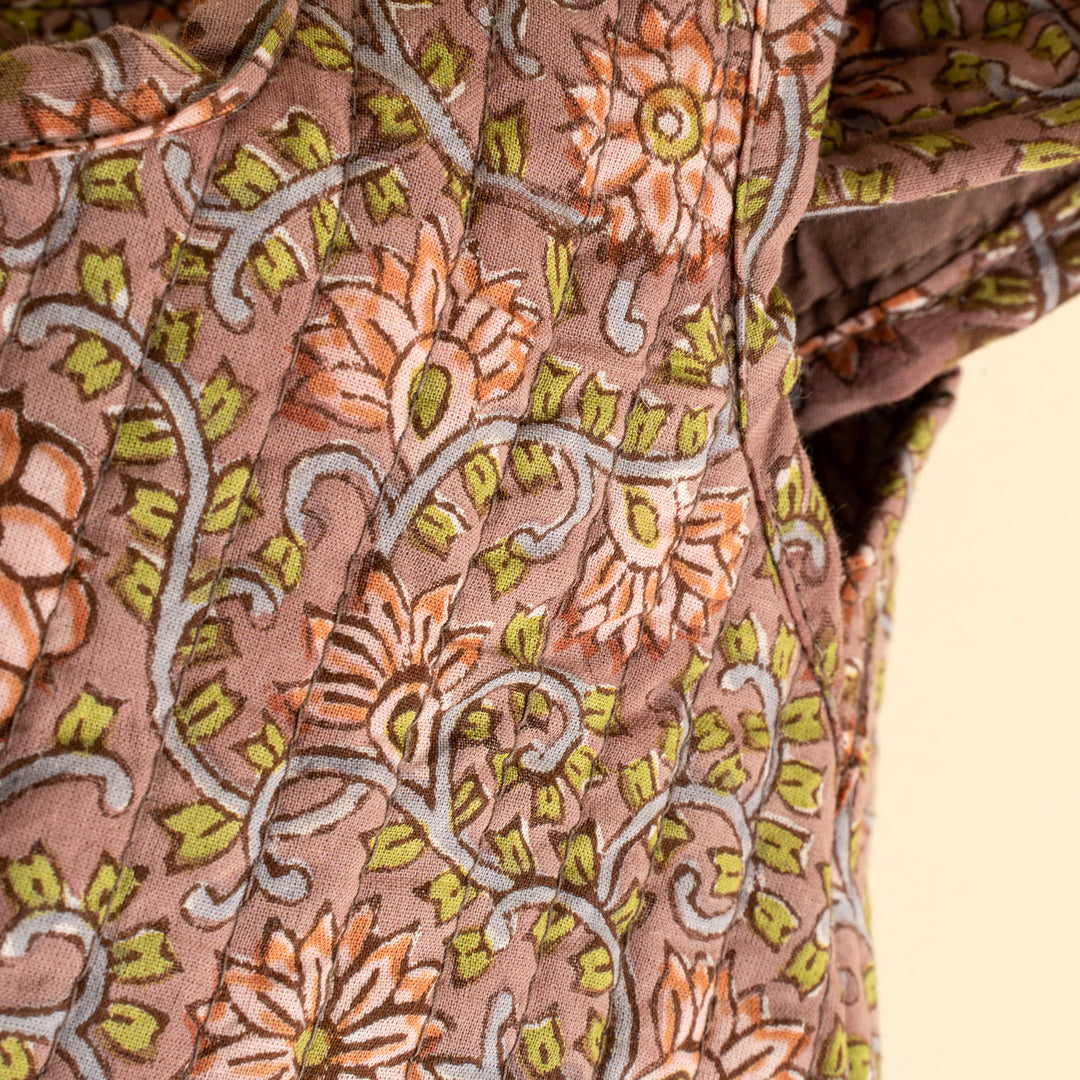 Indaba floral block print vanity pouch with vibrant floral pattern, compact design, and knot closure for travel or everyday use.