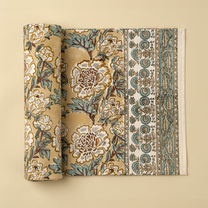 Lirien block print cotton table runner by Indaba featuring soft floral patterns on a white fabric background.
