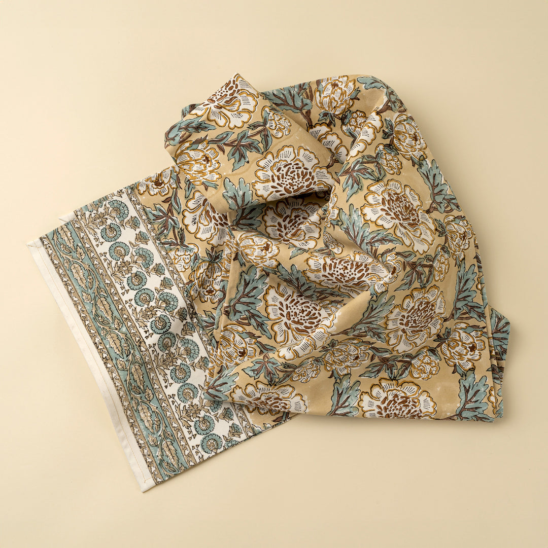 Lirien block print cotton table runner with colorful floral patterns, crafted by Indaba, laid out on a dining table.