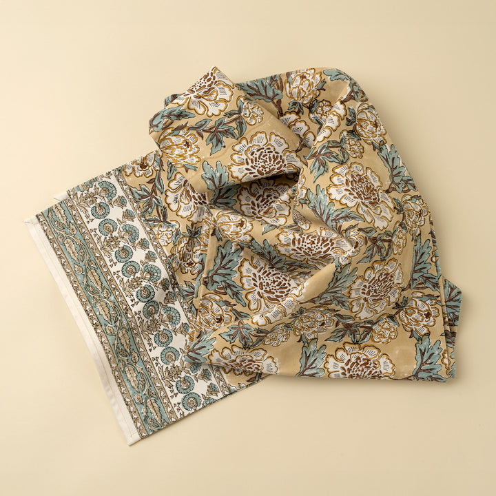 Lirien block print cotton table runner with colorful floral patterns, crafted by Indaba, laid out on a dining table.