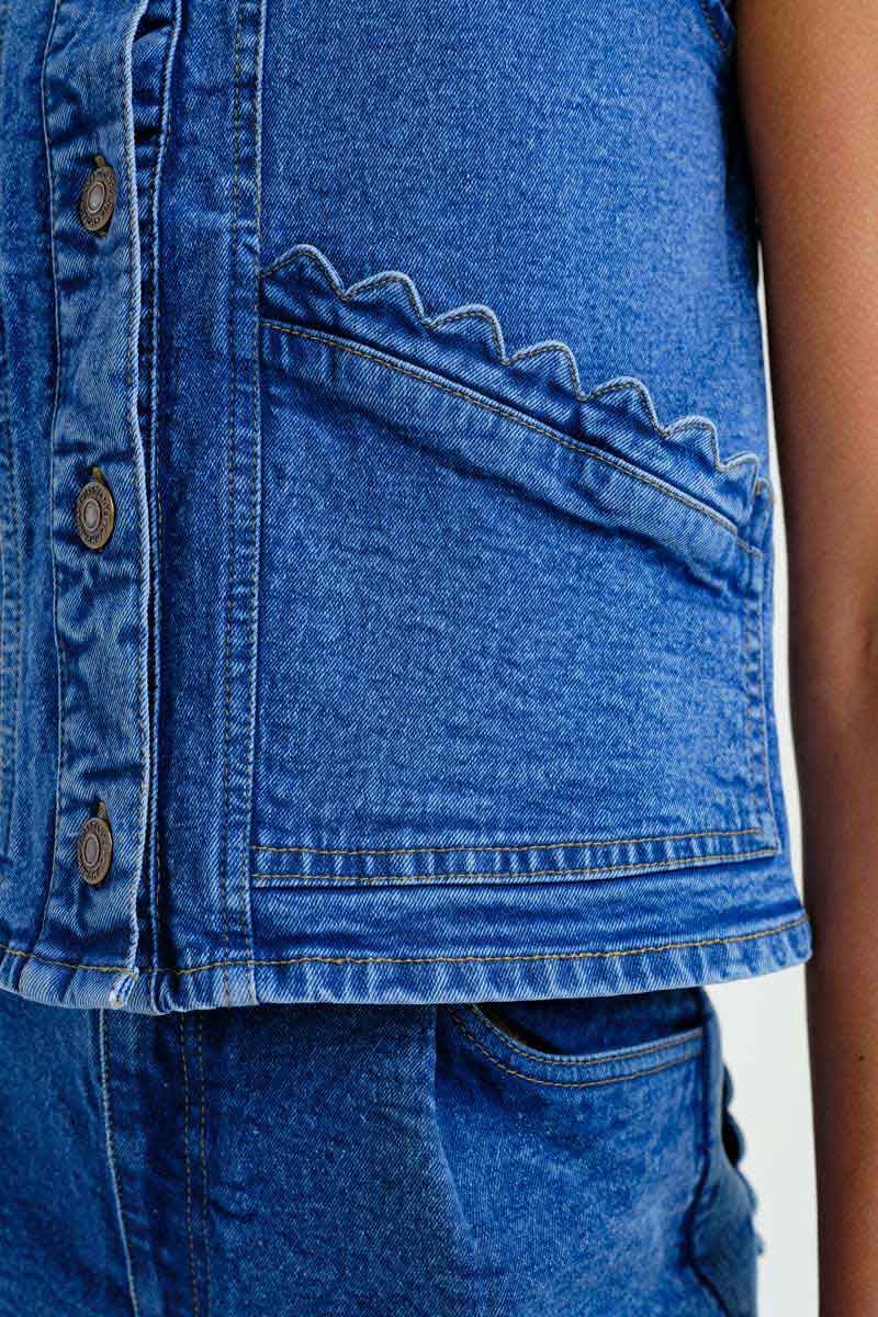 Light blue denim vest by Compania Fantastica with pocket details, stylish sleeveless design, and classic button closure.