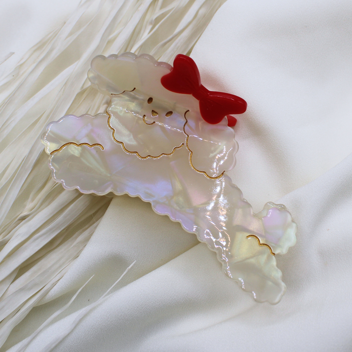 white fluffy dog hair clip with red bow in hair claw clip hair accessory poodle labrdoodle cute dog