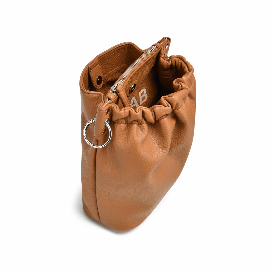 Colab Florence Bucket Bag featuring a stylish vegan leather exterior, drawstring closure, and adjustable shoulder strap.