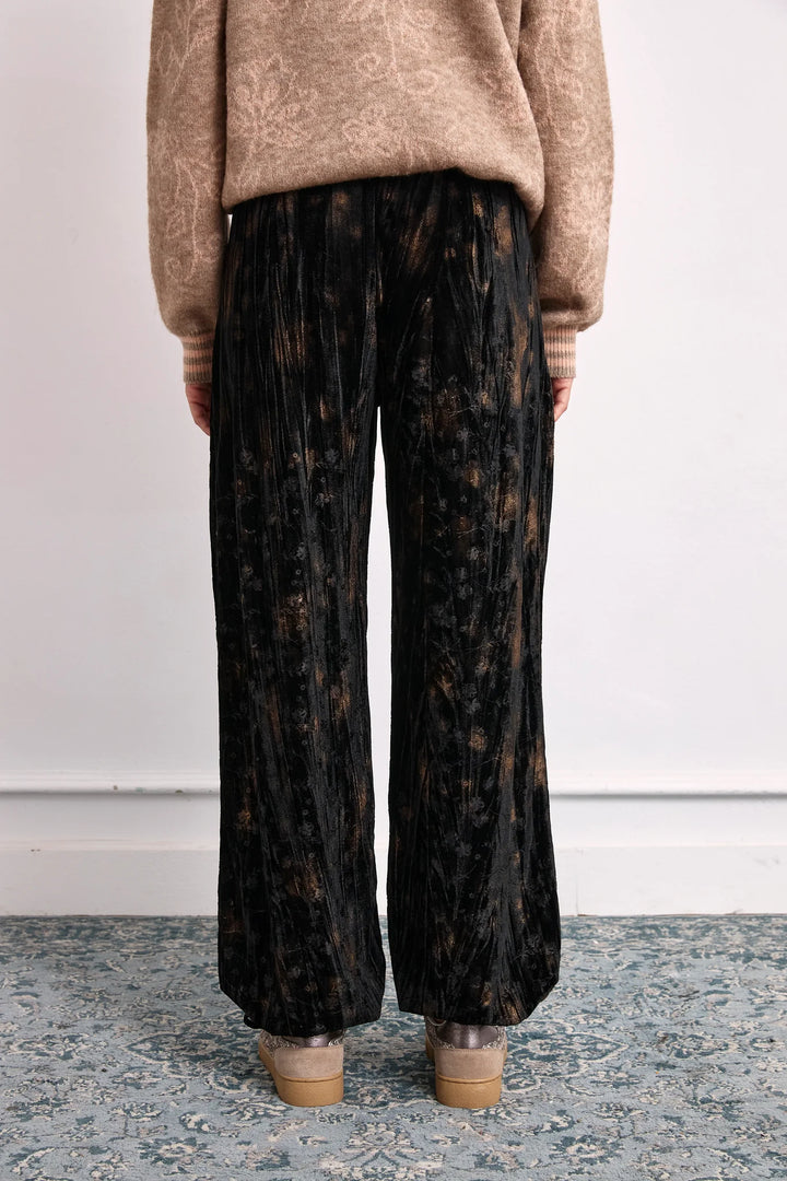 NKN Nekane Amara velvet tie cuff jogger pants featuring a printed velvet fabric and relaxed fit, shown in a stylish close-up image.