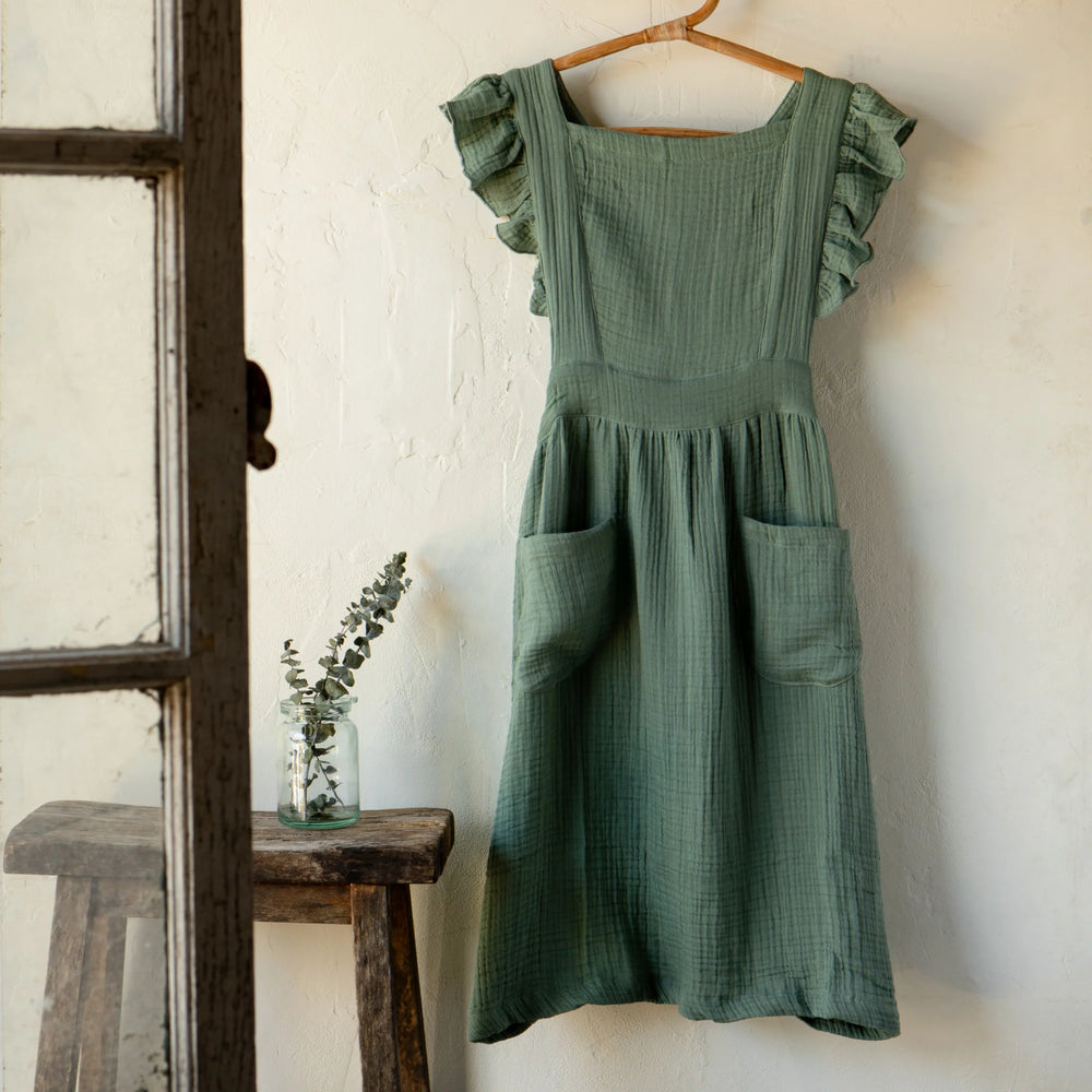 Danica Ada apron featuring a stylish, durable design with adjustable straps and a functional front pocket.