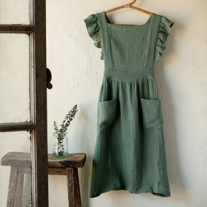 Danica Ada apron featuring a stylish, durable design with adjustable straps and a functional front pocket.