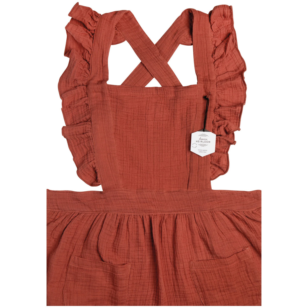 Danica Ada apron in vibrant fabric with adjustable neck strap and front pockets, designed for cooking and baking.
