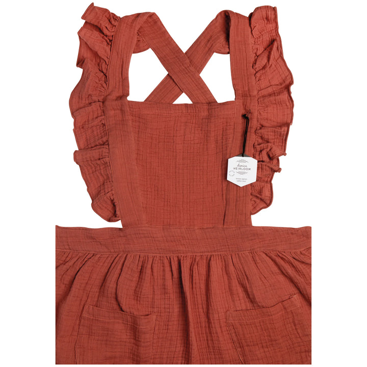 Danica Ada apron in vibrant fabric with adjustable neck strap and front pockets, designed for cooking and baking.