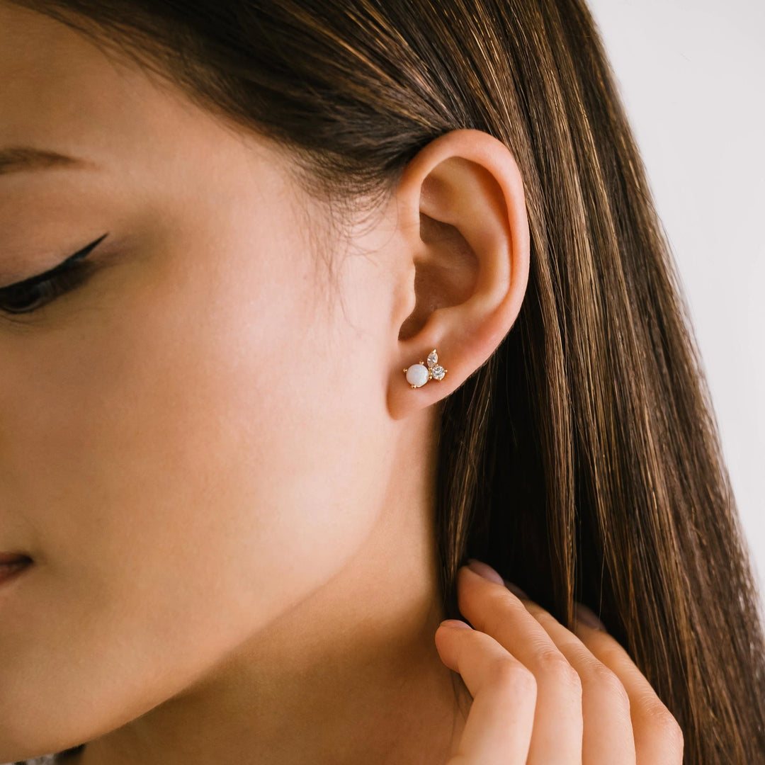 Lover's Tempo Adora Stud earrings featuring shiny, silver-toned metal with small, elegant gemstone accents on a white background.