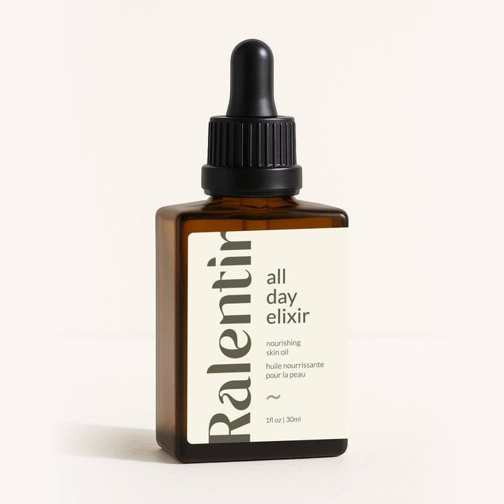 All Day Natural Skincare Elixir bottle with dropper, featuring a sleek glass container and natural skincare branding