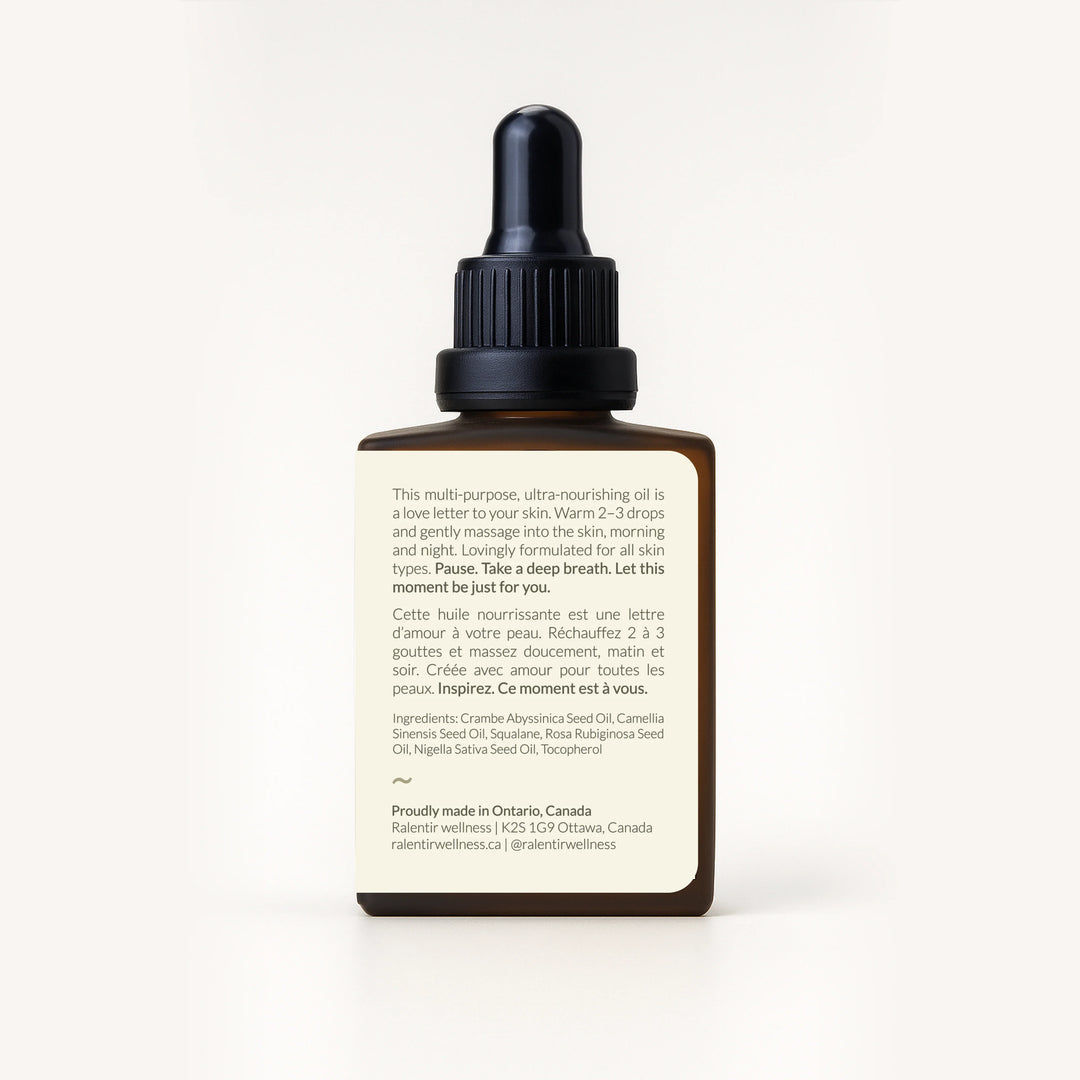 Bottle of Ralentir All Day Natural Skincare Elixir with dropper, showing a clear, nourishing facial skin care product.