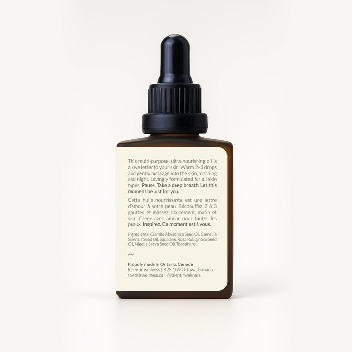 Bottle of Ralentir All Day Natural Skincare Elixir with dropper, showing a clear, nourishing facial skin care product.