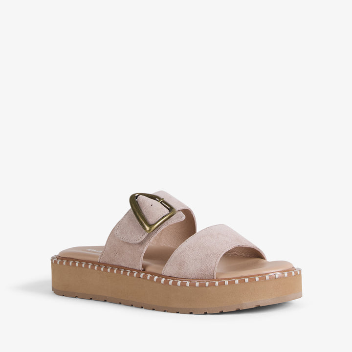 Beige sandal with a gold buckle on a white background