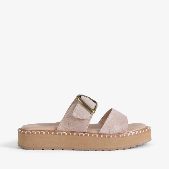 Beige sandal with a platform sole on a white background