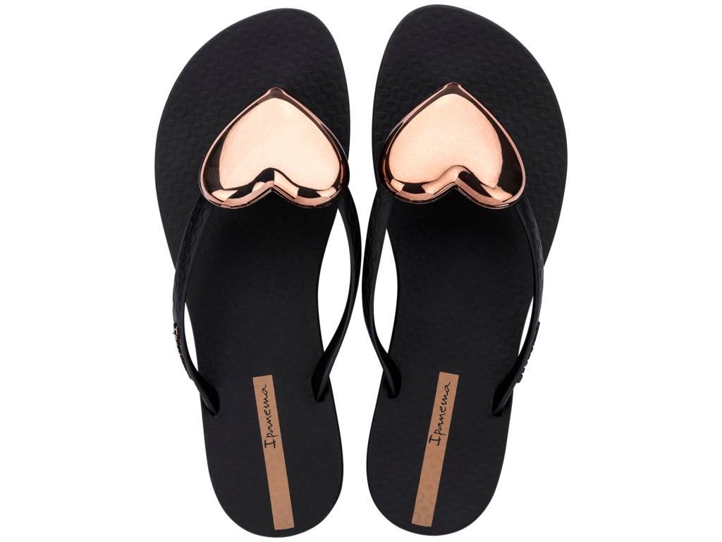 Black flip-flops with rose gold heart designs on a white background