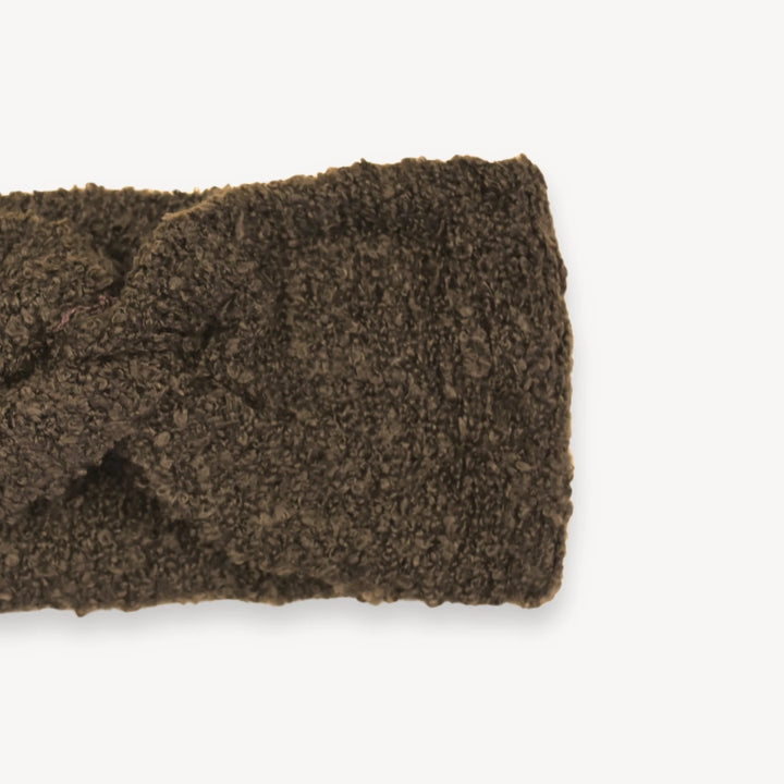 Brown knitted headband on a white background