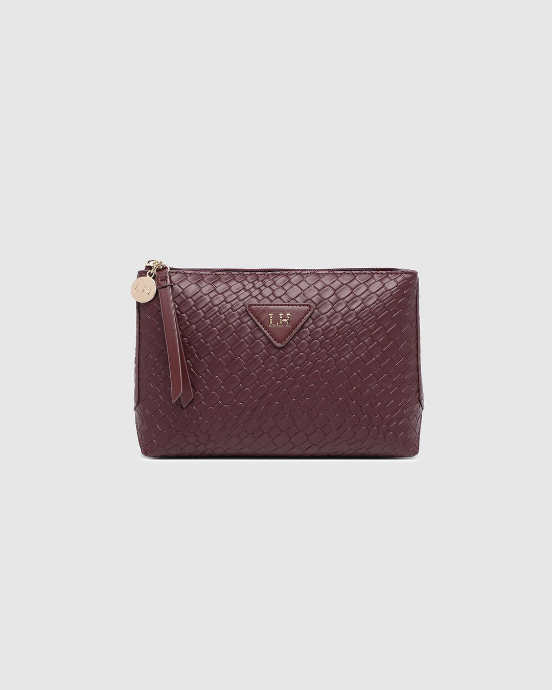 Burgundy leather pouch with gold zipper on a light gray background