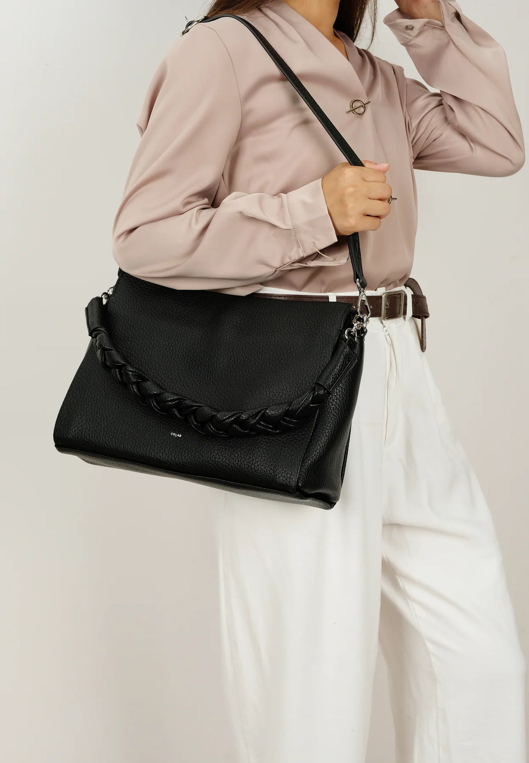 CoLab Camden crossbody bag with adjustable strap, featuring sleek design and multiple compartments for everyday use.