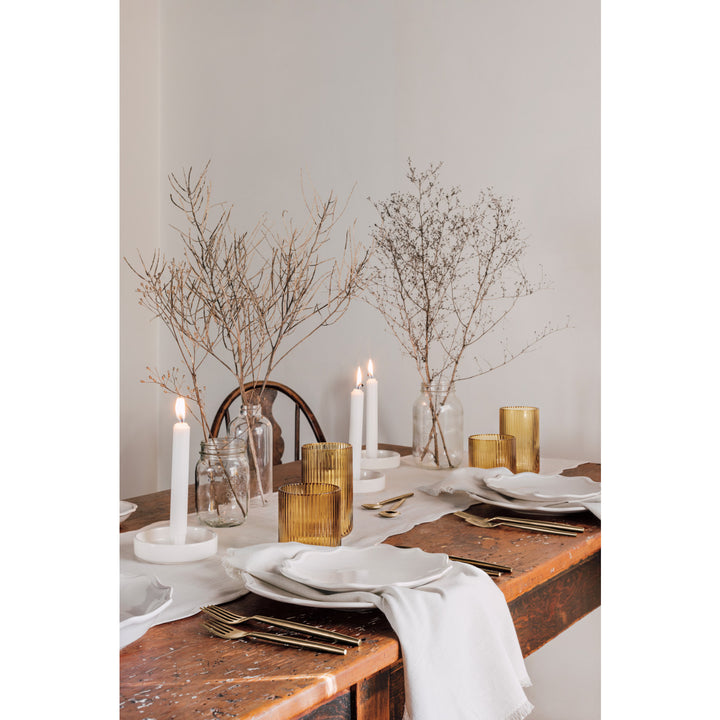 Set of Danica chambray cotton table napkins folded neatly on a table, showcasing their soft texture and classic beige color.