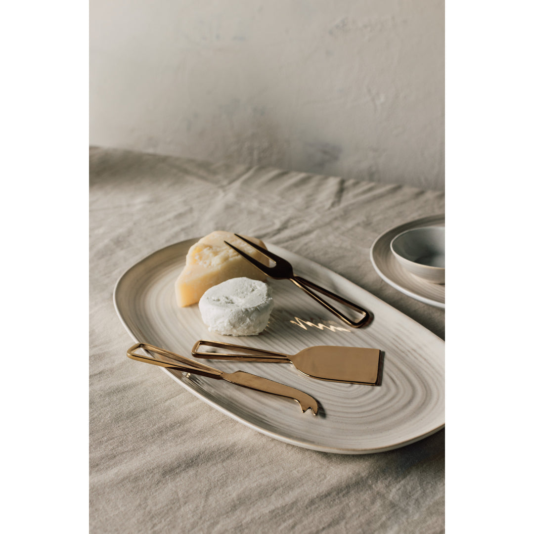 Danica gold cheese knife set with multiple cheese knives featuring elegant handles and sharp blades for serving cheese.