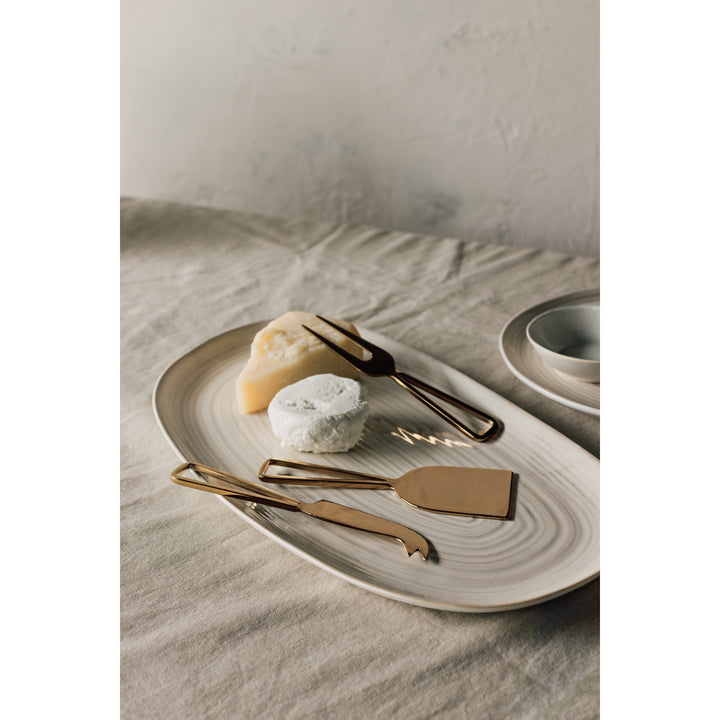 Danica gold cheese knife set with multiple cheese knives featuring elegant handles and sharp blades for serving cheese.