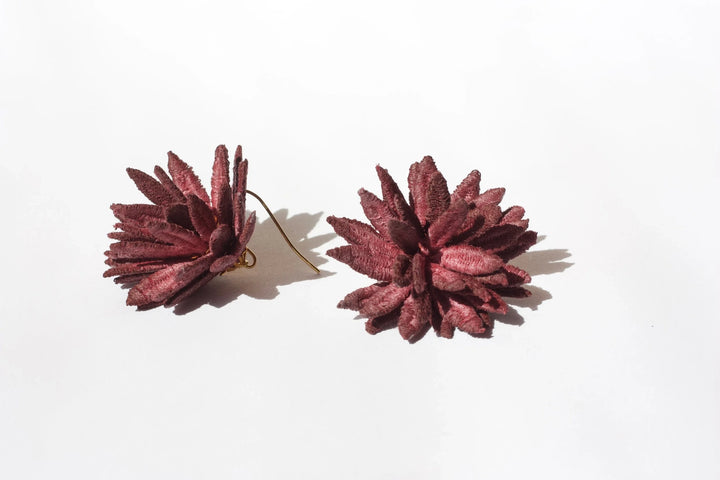 Burgundy chrysanthemum lace earring by Ilk Jewelry featuring intricate floral design and delicate craftsmanship.