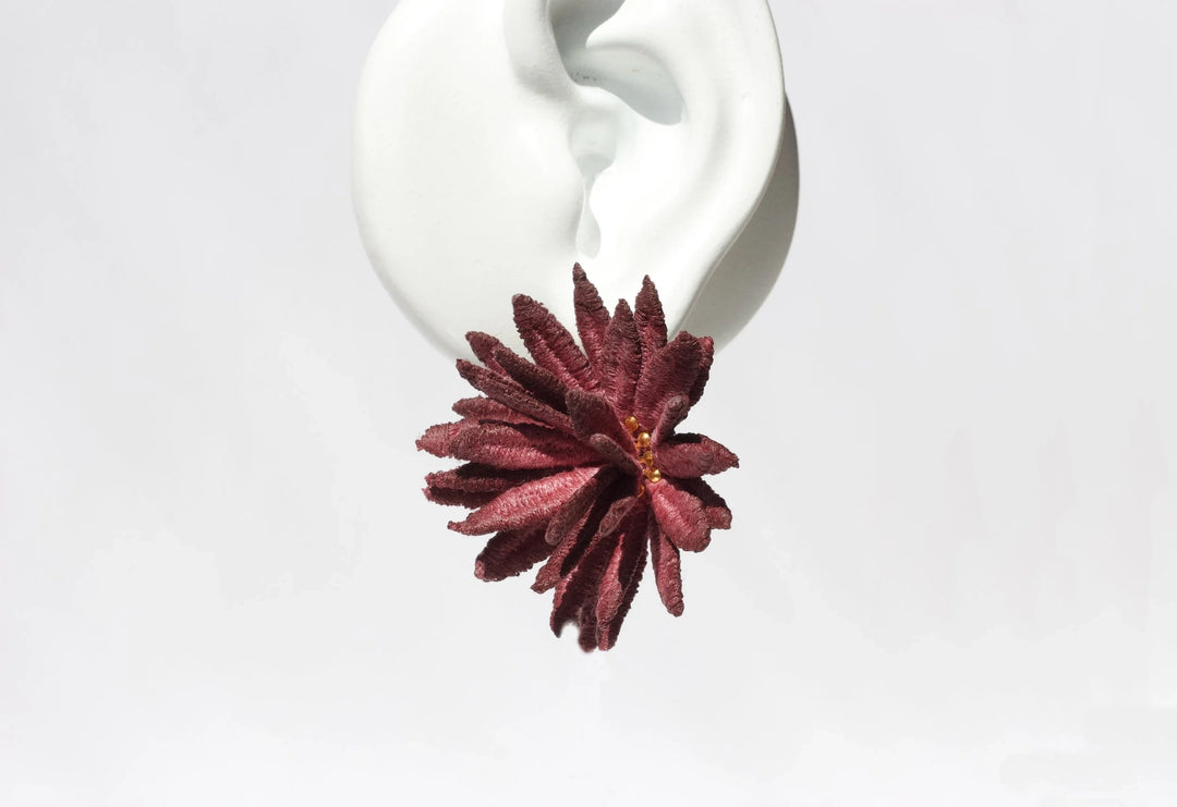 Burgundy chrysanthemum lace earring by Ilk Jewelry featuring floral design and intricate detailing.