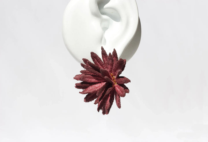 Burgundy chrysanthemum lace earring by Ilk Jewelry featuring floral design and intricate detailing.