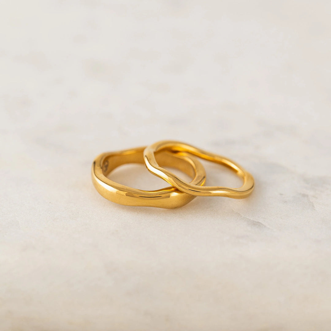 Lover's Tempo coral ring set featuring two wave shape rings on gold bands.
