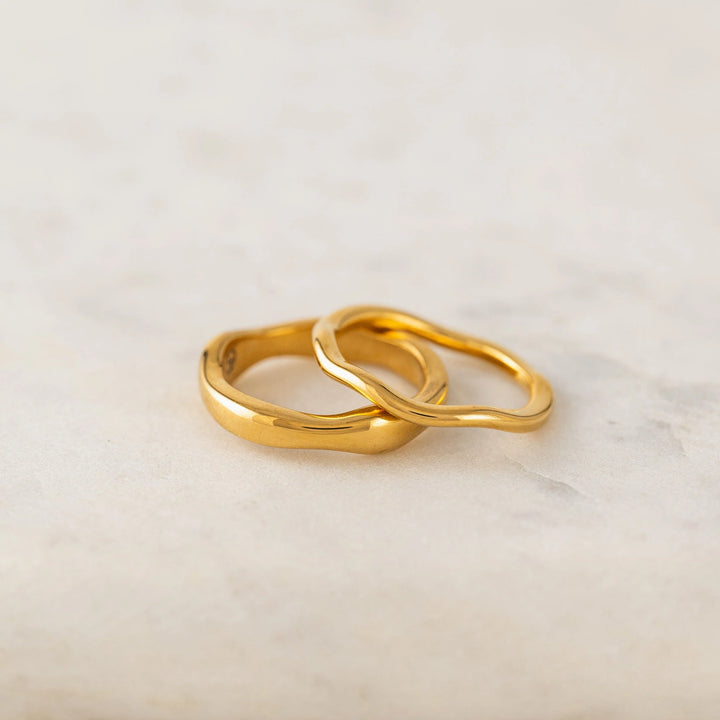 Lover's Tempo coral ring set featuring two wave shape rings on gold bands.
