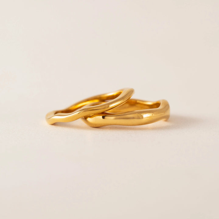 Lover's Tempo coral ring set featuring multiple stylish rings with wavy shape accents on a white background.