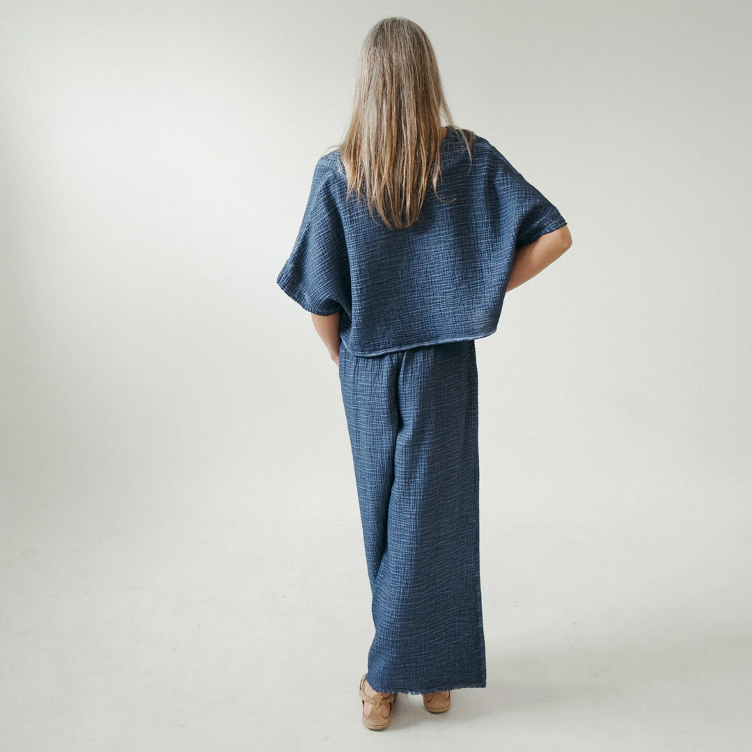 Pokoloko crinkle crop top with short sleeves, featuring a textured, lightweight fabric and a relaxed fit.