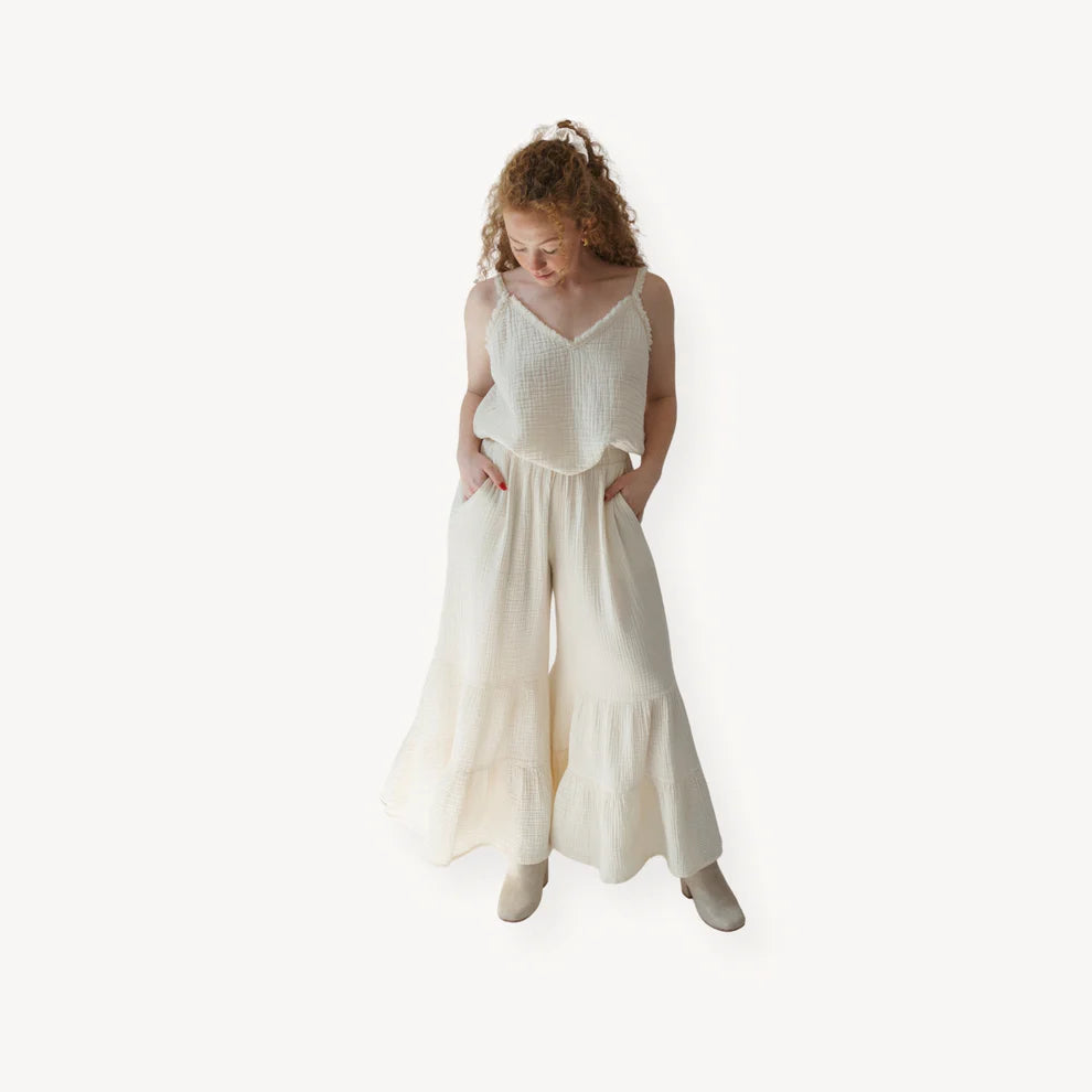 Crinkle cotton ruffled pants by Pokoloko featuring a relaxed fit, ruffle tiers on a flared leg, and lightweight, breathable fabric.