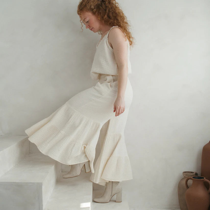 Pokoloko crinkle cotton ruffled pants featuring a relaxed fit, lightweight fabric, and feminine ruffle details in soft neutral tones.