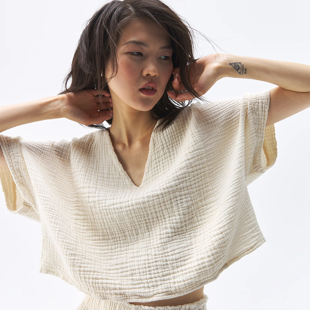 Pokoloko crinkle crop top with short sleeves, lightweight fabric, and textured crinkle design, perfect for casual summer wear.