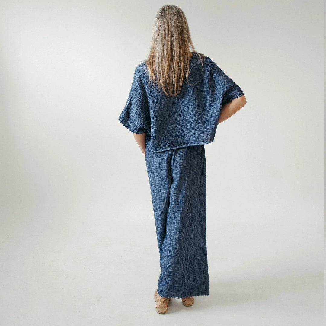 Pokoloko crinkle denim palazzo pants with wide-leg silhouette and textured fabric, perfect for comfortable loungewear style.