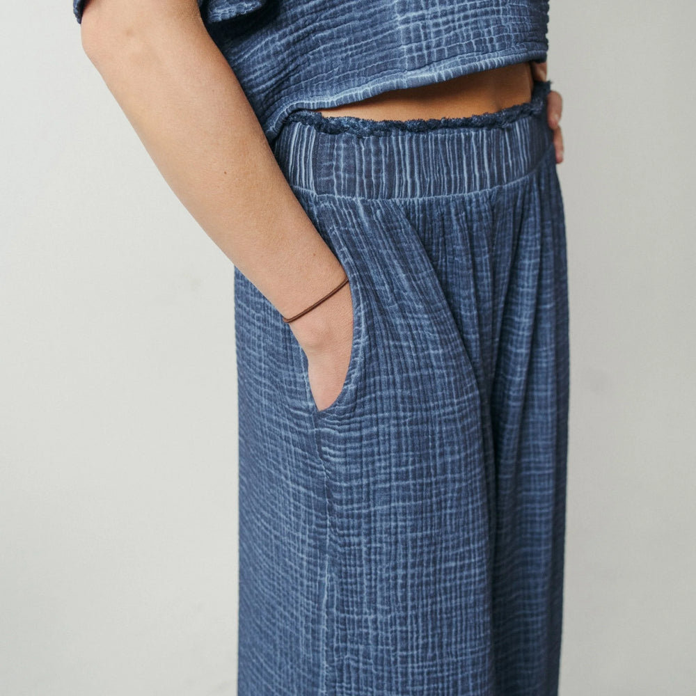 Light blue crinkle Palazzo pants from Pokoloko's loungewear collection, featuring a flowy, relaxed fit with wide legs.
