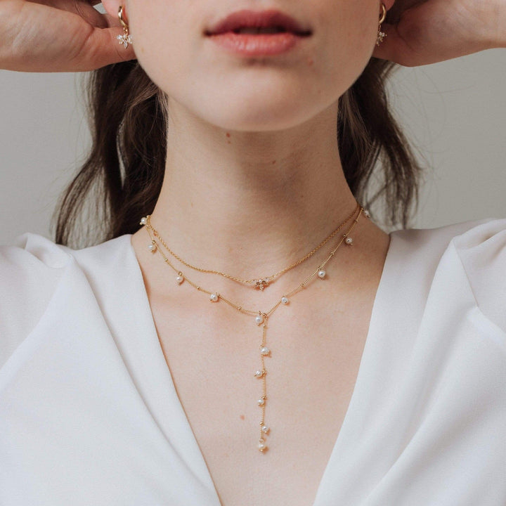 Lover's Tempo Dot Pearl Gold Lariat Necklace featuring delicate pearl accents and a sleek gold chain for elegant style.