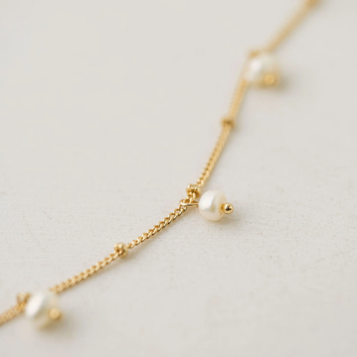 Gold lariat necklace with dot pearl accents from Lover's Tempo, showcasing a stylish and elegant jewelry piece.